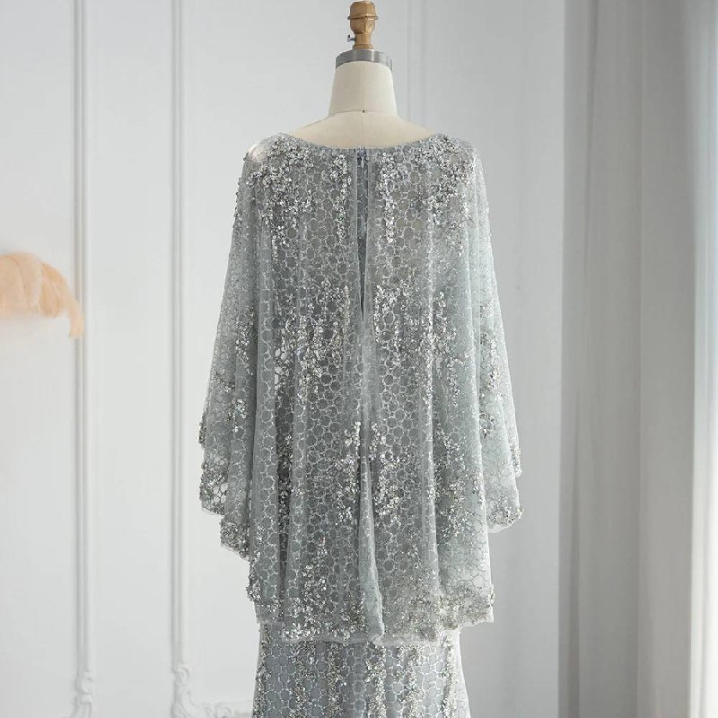 Second image of Silver Celestial Encrusted Gown with Dramatic Draped Cape Sleeves