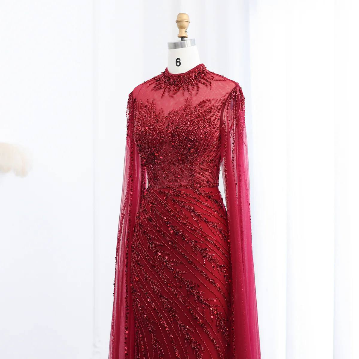 Second image of Ruby Radiance Encrusted Mermaid Gown with High Neck and Draped Cape Sleeves