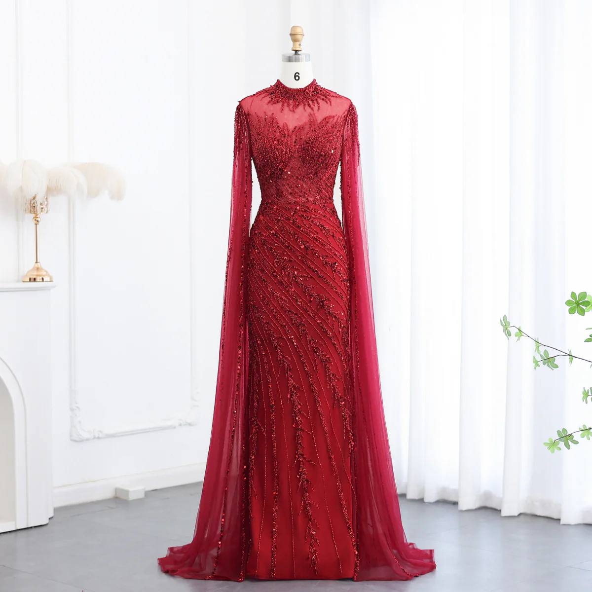 Ruby Radiance Encrusted Mermaid Gown with High Neck and Draped Cape Sleeves