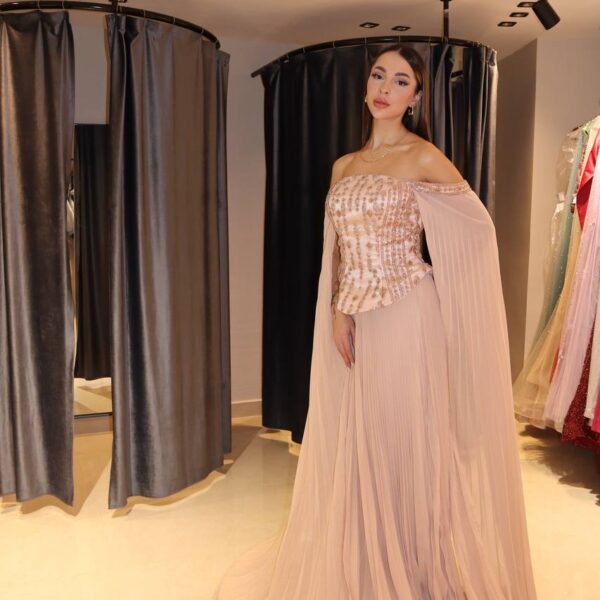 Blush-Nude Pleated Chiffon Gown with Jeweled Corset and Dramatic Cape Sleeves