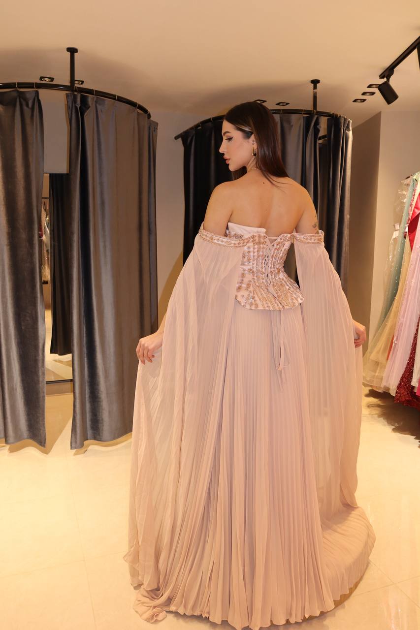 Second image of Blush-Nude Pleated Chiffon Gown with Jeweled Corset and Dramatic Cape Sleeves